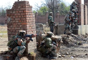 Indian army soldiers take position near a building where militants were holed up during a gunfight in Sempora Pampore, some 15 kms south of Srinagar, the summer capital of Indian Kashmir, 21 February 2016.