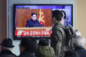 A South Korean army soldier passes by a TV news program showing North Korean leader Kim Jong Un's New Year speech, at the Seoul Railway Station in Seoul, South Korea, Friday, Jan. 1, 2016.