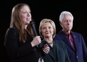 Chelsea Clinton, left, speaks while Democratic presidential candidate Hillary Clinton, center, and former President Bill Clinton listen during a rally Friday, Feb. 19, 2016, in Las Vegas.