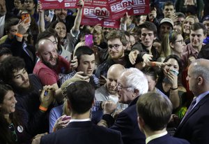 Democratic presidential candidate Sen. Bernie Sanders, I-Vt., below center right, greets people in the crowd at the conclusion of a campaign rally, Monday, Feb. 22, 2016, in Amherst, Mass.