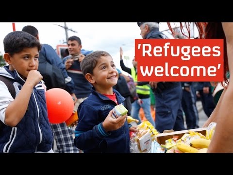 Refugees cheered into Germany and Austria