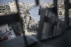 In this Sunday, Oct. 28, 2012 photo, street of shattered buildings is viewed partially through a mirror used by rebel fighters to keep an eye on their enemy's positions in the Karm al-Jabel battlefield in Aleppo, Syria. Syria's air force fired missiles and dropped barrel bombs on rebel strongholds while opposition fighters attacked regime positions, flouting a U.N.-backed cease-fire that was supposed to quiet fighting over a long holiday weekend but never took hold. (AP Photo/Narciso Contreras).