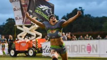 Canberra Mustangs Lauren Ashleigh flies the team flag on the field.