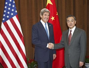 U.S. Secretary of State John Kerry, left, poses with Chinese Foreign Minister Wang Yi prior to their meeting at the Chinese Foreign Ministry Saturday, April 13, 2013 in Beijing. The question of how Washington can persuade Beijing to exert real pressure on North Korean leader Kim Jong Un's unpredictable regime is front and center as Kerry meets Saturday with Chinese leaders in Beijing.