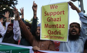 Supporters of Pakistani religious parties rally to support Mumtaz Qadri, who allegedly killed Punjab's governor Salman Taseer, in Karachi, Pakistan, Friday, Oct. 9, 2015. Pakistan's Supreme Court has upheld the death sentence for a former police officer convicted of killing a provincial governor he had accused of blasphemy.