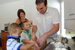 Josh Lawler cooking with (from front) sons Oliver and Cole and wife Colleen, holding Lucy, then a baby, in 2013. 