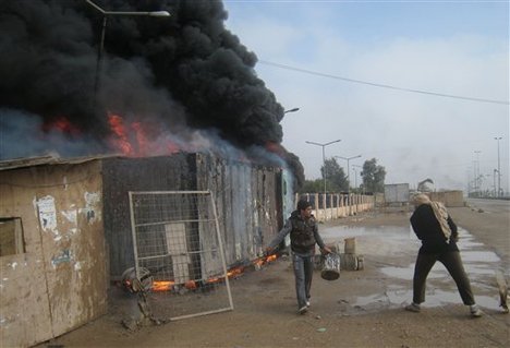 clashes between Iraqi army soldiers and Sunni gunmen in Fallujah, 65 kilometers (40 miles) west of Baghdad, Iraq, Tuesday, Dec. 31, 2013. Iraqi police took down tents and cleared a Sunni protest camp sit-in in Ramadi, 115 kilometers (70 miles) west of Baghdad