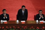 Chinese Vice Premier LI Keqiang, right, and LIu Yunshan, left, Director of Chinese Communist Party's Propaganda Department, clap while Zhou Yongkang, center, member of Chinese Communist Party Politburo Standing Commitee, is introduced during a conference to celebrate the 90th anniversary of the founding of Chinese Communist Youth League at the Great Hall of the People in Beijing, China, Friday, May 4, 2012.