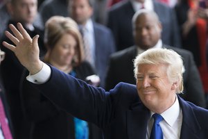 Republican presidential candidate Donald Trump waves to attendees during a campaign stop at the Signature Flight Hangar at Port-Columbus International Airport, Tuesday, March 1, 2016, in Columbus, Ohio.