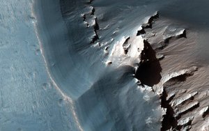 File - This image, acquired on Nov. 24, 2015 by the High Resolution Imaging Science Experiment (HiRISE) camera aboard NASA's Mars Reconnaissance Orbiter, shows the western side of an elongated pit depression in the eastern Noctis Labyrinthus region of Mars.