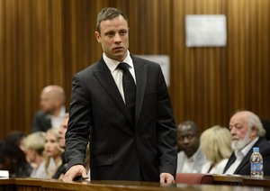 File - Oscar Pistorius arrives in court in Pretoria, South Africa, Tuesday, Oct. 21, 2014.