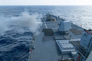 File - The Arleigh Burke-class guided-missile destroyer USS Curtis Wilbur (DDG 54) conducts a live fire gunnery exercise with its 5-inch .54-caliber gun in the South China Sea, 15 January, 2016.