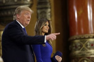 Republican presidential candidate, businessman Donald Trump arrives at the spin room his wife Melania after a Republican presidential primary debate at Fox Theatre, Thursday, March 3, 2016, in Detroit.