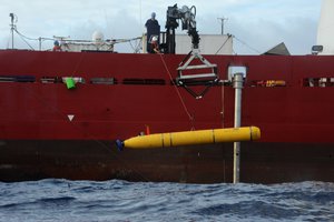 U.S. Navy contractors lower the Bluefin-21 into the Indian Ocean from the deck of the Australian Defence Vessel Ocean Shield, 26 April, 2014. The submersible is being utilized to search for missing Malaysia Airlines flight MH 370.