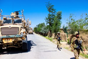 File - Georgian soldiers and U.S. Marines patrol a village in Parwan province near Bagram Airfield, Afghanistan, July 10, 2015.