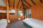 A lodge bedroom with three beds : Jemby Rinjah Eco Cabins x 13 Cabins in Blackheath