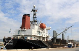 In this March 4, 2016 file photo, crewmen of the North Korean cargo vessel Jin Teng stand on the middle of the deck as it unloads its cargo while docked at Subic Bay, in Zambales province, northwest of Manila, Philippines.