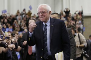 Democratic presidential candidate, Sen. Bernie Sanders, I-Vt, pumps his fist as he arrives for at a rally at the Macomb Community College, Saturday, March 5, 2016, in Warren, Mich.