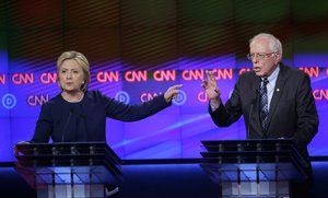 Democratic presidential candidates Hillary Clinton, left, and, Sen. Bernie Sanders, I-Vt., argue a point during a Democratic presidential primary debate at the University of Michigan-Flint, Sunday, March 6, 2016, in Flint, Mich.