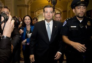 Sen. Ted Cruz, R-Texas, walks with security after talking to reporters on Capitol Hill, Wednesday, Oct. 16, 2013, in Washington. Sen. McConnell and his Democratic counterpart, Senate Majority Leader Harry Reid, D-Nev., are optimistic about forging an eleventh-hour bipartisan deal preventing a possible federal default and ending the partial government shutdown after Republican divisions forced GOP leaders to drop efforts to ram their own version through the House.