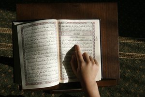 A Palestinian boys read the Koran at a Mosque in their summer camp for the study of Islam's holy book organized by the Islamist movement Hamas in Rafah in the southern Gaza Strip on June 7, 2014. A summer camp by Hamas for school students teaches Koran recitation and interpretation, and learn about the Prophet Muhammad and other lessons in Islam. Photo by Ahmed Deeb/WN