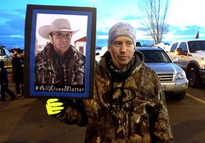 Tony Atencio of Burns, Oregon, holds a photo of rancher Robert ``LaVoy'' Finicum at a rally against in Burns, Ore.