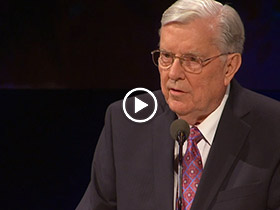 Elder Ballard at pulpit from video