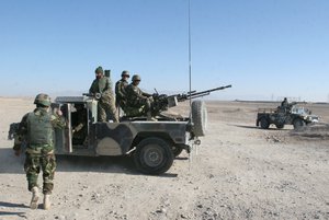 Afghan National Army soldiers guard at a checkpoint on the way to the Sangin district of Helmand province, Afghanistan, Wednesday, Dec. 23, 2015.