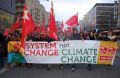 System Change not climate change banner in Warsaw