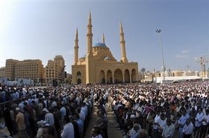 Lebanese people perform Friday first prayer in front of Mohammed al-Amin Mosque in Downtown Beirut, Lebanon