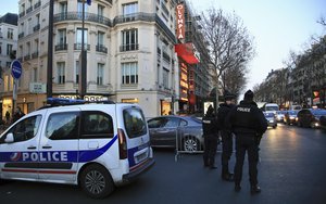 File - Police officers secure the area around the Olympia music hall before the Eagles of Death Metal's concert, in Paris, Tuesday, Feb. 16, 2016.