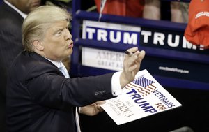 Republican presidential candidate Donald Trump signs autographs during a campaign rally in Fayetteville, N.C., Wednesday, March 9, 2016.