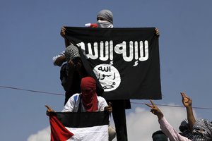 Protesters hold up a flag of the Islamic State of Iraq and the Levant (ISIL),shouts slogans during a protest against Israeli military operations in Gaza.