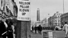 Life goes on after Nelson's Pillar is bombed on Dublin’s O’Connell Street 