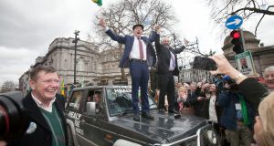 Michael and Danny Healy Rae on the bonnet of a car  outside Leinster House. Photograph: Alan Betson / The Irish Times


