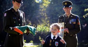 Mary Hannon (10) wears her great-grandfather’s Old IRA service medal, with Lieut Stephen Cunningham and Sgt Amy Hopkins. Photograph: Eric Luke/The Irish Times