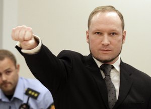 Mass murderer Anders Behring Breivik, makes a salute after he arrives at the court room in a courthouse in Oslo Friday Aug. 24, 2012