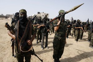 A Palestinian Islamic Jihad militants take part in a rally with guns, vehicles and marching marking the 17th anniversary of the killing of Fathi Shiqaqi, the militant movement's founder, in Rafah in the southern Gaza Strip on October 2, 2012. The militants have accused Israel's spy agency Mossad of assassinating Shiqaqi in Malta in 1995.Photo by Ahmad Deeb / WN