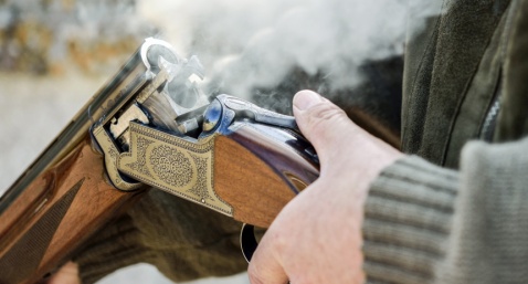 A smoking 12 bore shotgun having ejected spent a cartridge (Shutterstock.com)