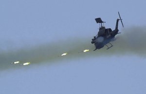 In this April 20, 2001 file photo, a Taiwan Army Bell AH-1W Super Cobra helicopter fires "hellfire" missiles off the southern coast of Taiwan during a military exercise, in Pingtung County.