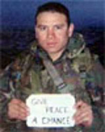 Ex-Sgt. Camilo Mejia holding an anti-war sign in Iraq. After refusing to report for duty, he was sentenced to a year in jail.