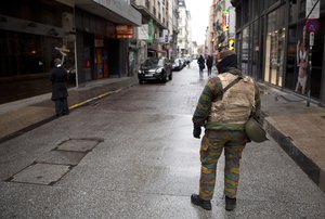 File - A Belgian Army soldier patrols a main shopping street in Brussels on Saturday, Nov. 21, 2015.