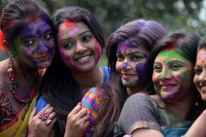 Indian artists pose after covering each other with coloured powder as they rehearse a dance for the upcoming ...