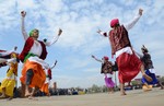 Indian Border Security Force Soldiers (BSF) dance as they celebrate during the Holi festival inside a camp in Srinagar on March 27, 2013. Holi, also called the Festival of Colours, is a popular Hindu spring festival observed at the end of the winter season on the last full moon day of the lunar month.