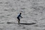 A paddle boarder makes his way past Wedding Cake Island off Coogee.