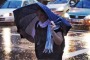 A woman battles a soggy morning commute in Darlinghurst on Tuesday.