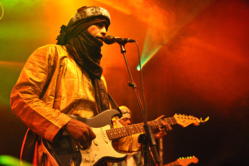 Tinariwen perform on March 19, 2012 in Barcelona, Spain. This band, composed of Tuareg musicians from the Sahara Desert region of Mali, appears on Kevin Gosztola's list of the best protest music of the decade so far. (Flickr / ScannerFM)