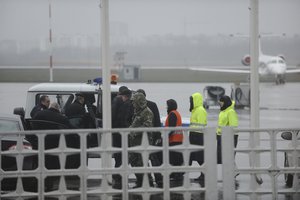 Russian Emergency Situations Ministry employees and police are seen as they take a car to drive to the area of the plane crash at the Rostov-on-Don airport, about 950 kilometers (600 miles) south of Moscow, Russia Saturday, March 19, 2016.