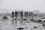Investigators, members of Russia's Emergencies Ministry and other services work at the crash site of a Boeing 737-800 operated by Dubai-based budget carrier Flydubai, at the airport of Rostov-On-Don, Russia, March 19, 2016.