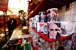 A Syrian vendor sells mugs bearing portraits of Russian President Vladimir Putin (bottom) and Syrian President Bashar Assad (top) in the popular Hamidiyeh market in the old part of the capital Damascus on November 26, 2015